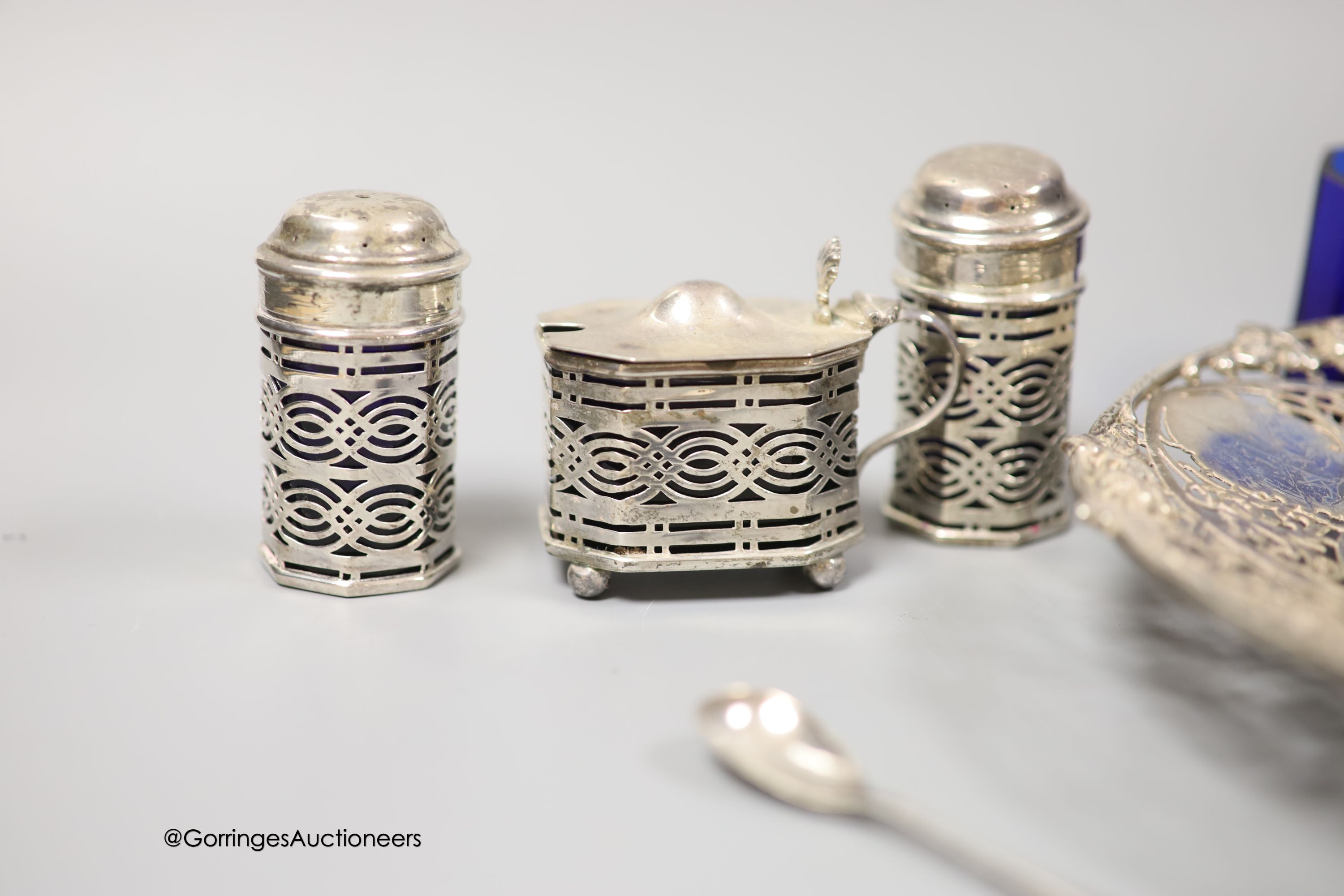 A modern pierced silver shallow dish, S.J. Rose & Son, Sheffield, 1964, 20.3cm and a late Victorian silver six piece condiment set, with two spoons, Birmingham, 1897, one liner missing and one extra liner